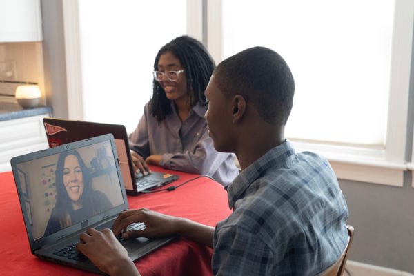 Students attending to an online class together at home